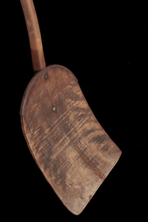 Primitive wooden shovel with an early repair, simple form