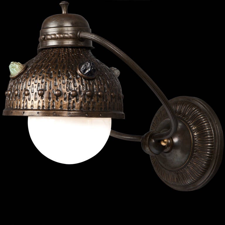 Arts and Crafts era wall sconce, with details brass shade, featuring ornamental crystals.

Made in England circa 1920 - 1930.
