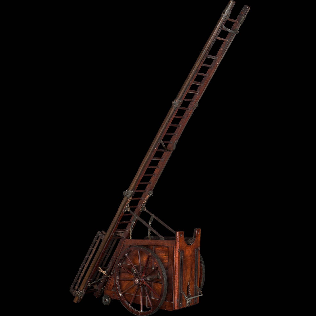 Mahogany, steel, brass, copper, and rope patent model. Lever on the front of the cart that when pulled down and locked in place, raises the ladder on two geared arms with a drawstring.