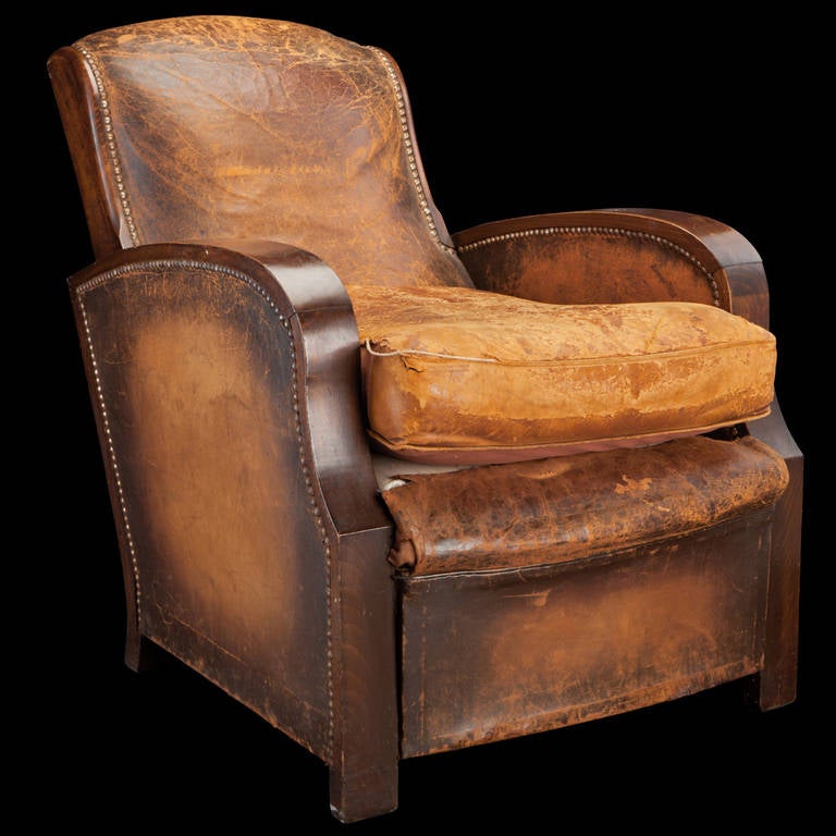 Well worn leather lounge chair, fitted with brass nails on solid wood frame.

France circa 1930