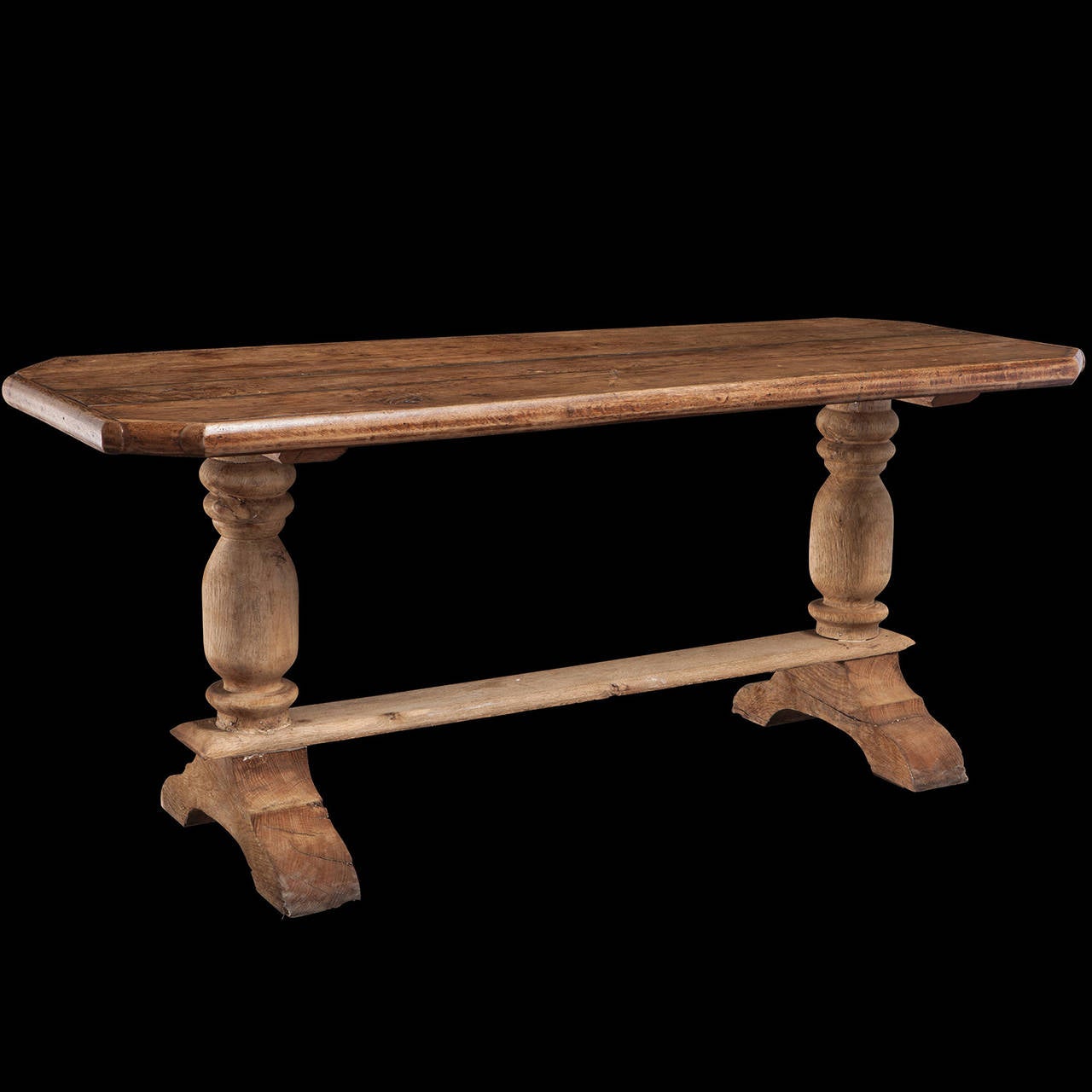Three plank top with turned legs and trestle base.
