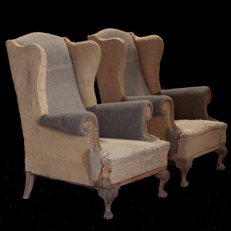 Pair of primitive tall wingback lounge chairs with unusual tattered grey/beige burlap fabric