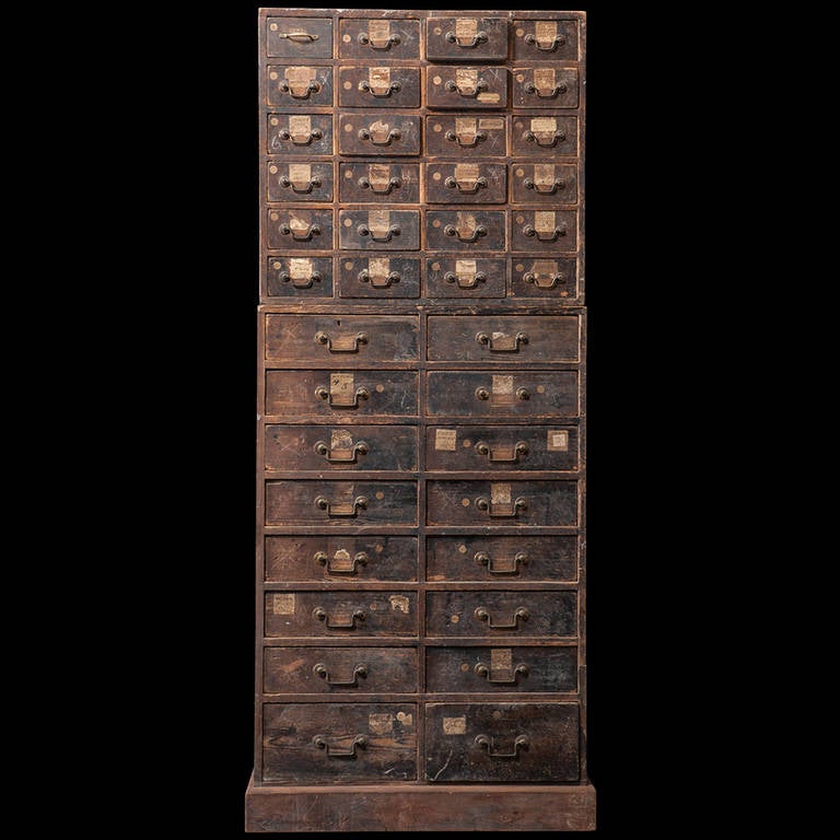 A towering chest of drawers from a 19th english century pawn shop. Many labels still in tact labeling drawer contents such as watches, brooches, rings, medals...