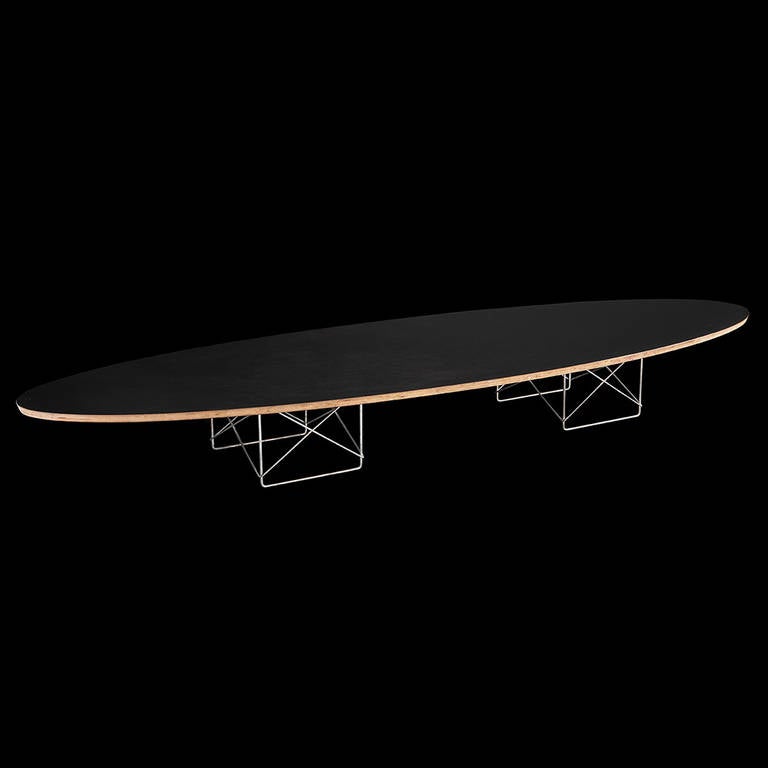 Original surfboard table with seven-ply Baltic birch core and black laminate surface on wire-rod base.

Designed by Charles and Ray Eames for Herman Miller circa 1951.
