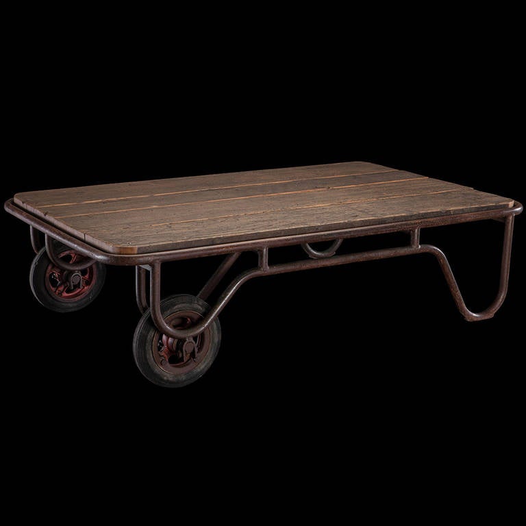 Factory car with oak plank top, steel frame and original red metal / rubber wheels.

Made in Belgium circa 1910.