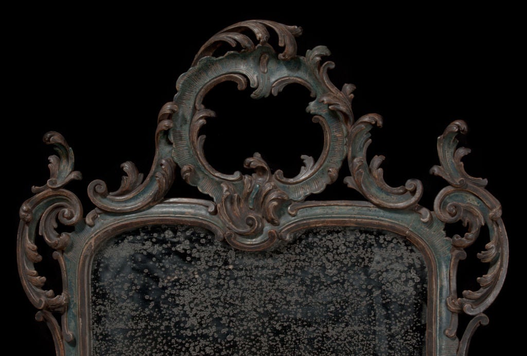 Hand carved ornate mirror with original mercury glass and wood slatted back.