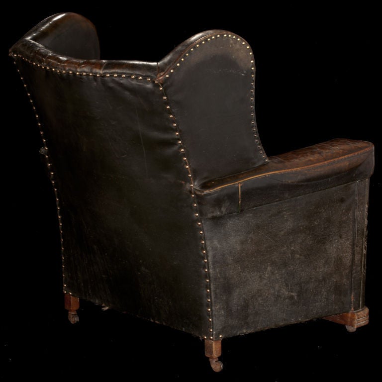 Leather deco club chair with channel back and unusual velvet floral pillow