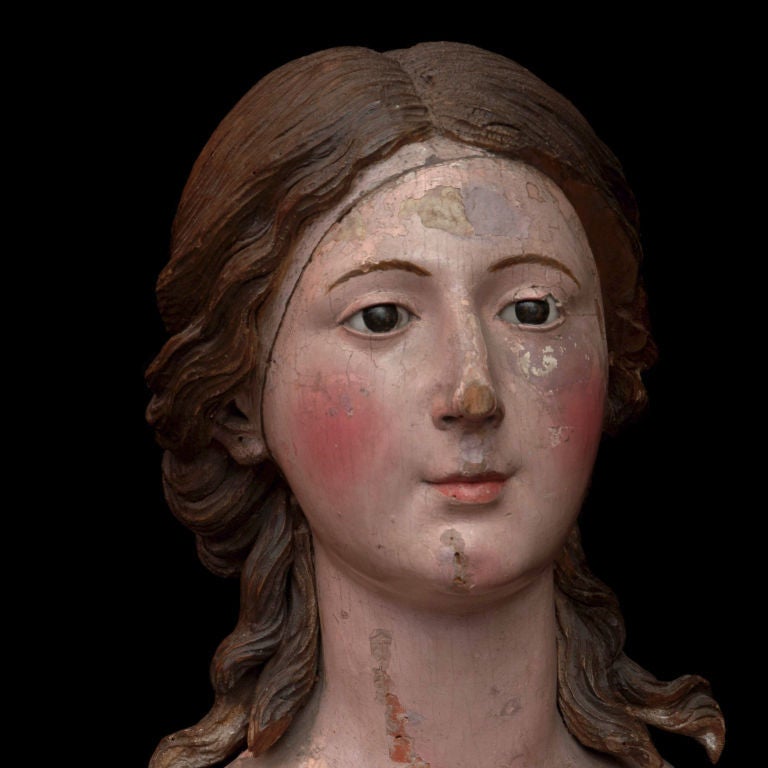 Santos head, wood carving, finely detailed original painted surface, glass eyes, delicate features.