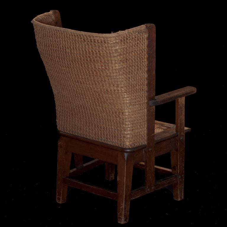 Primitive child's orkney chair with beechwood arms and frame with rush back and seat.