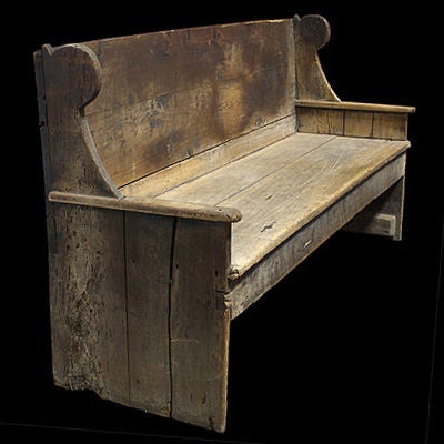Primitive bench with unusual side wingbacks, squared off construction.
