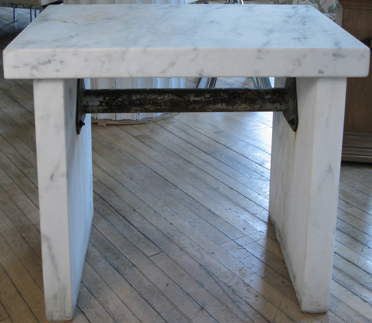 a fabulous antique candy makers table, comprised of beautiful white marble with pale grey veins, in three inch thick slabs, the uprights connected by a cast iron center. spare elegant form, in the best of materials!