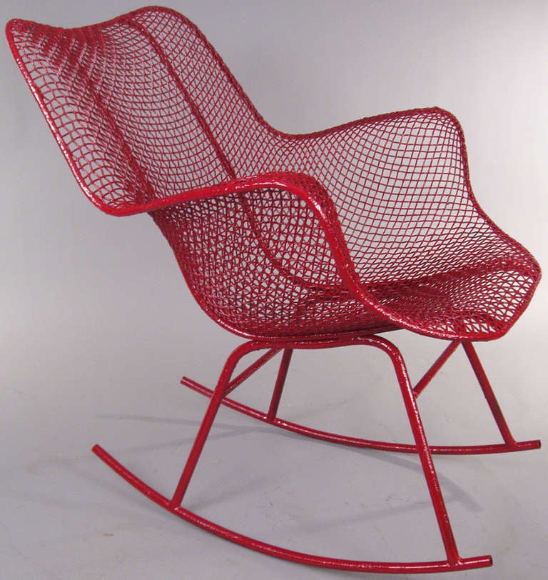 the classic and iconic vintage steel mesh high back Sculptura Rocking Chair designed in 1950 by Russell Woodard. finished in red. a pair available, priced individually.