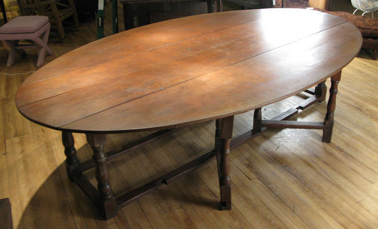 20th Century Antique English Oak Drop Leaf Oval Table