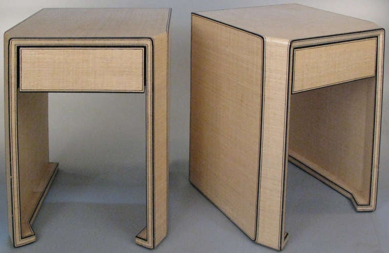 a beautiful pair of vintage 1970's nightstands in the style of Karl Springer, with an open base and single drawer. covered in lacquered linen, with ebony trim, these have beautiful details with flat corners and finished backs. excellent condition
