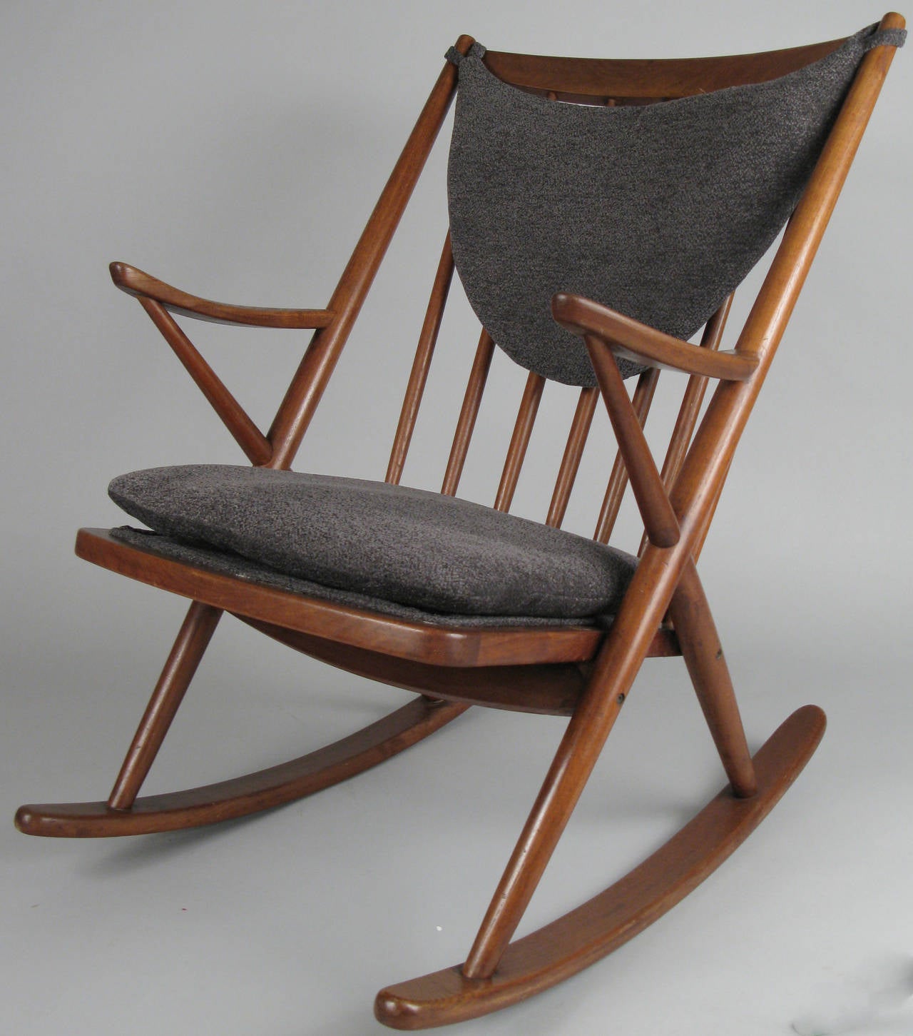 A very nice vintage 1950s Danish teak rocking chair designed by Frank Reenskaug for Brahmin. Beautiful lines and proportions, with new upholstered seat and back cushions.
