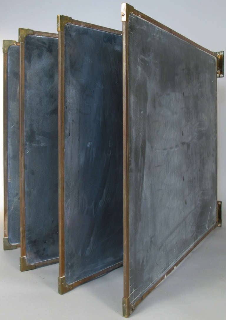 an amazing set of antique slate chalkboards in their original frames with bronze corners, along with the bronze wall mounted brackets that hold them all and allow them to pivot to use both sides of the boards. beautiful set in very good condition.