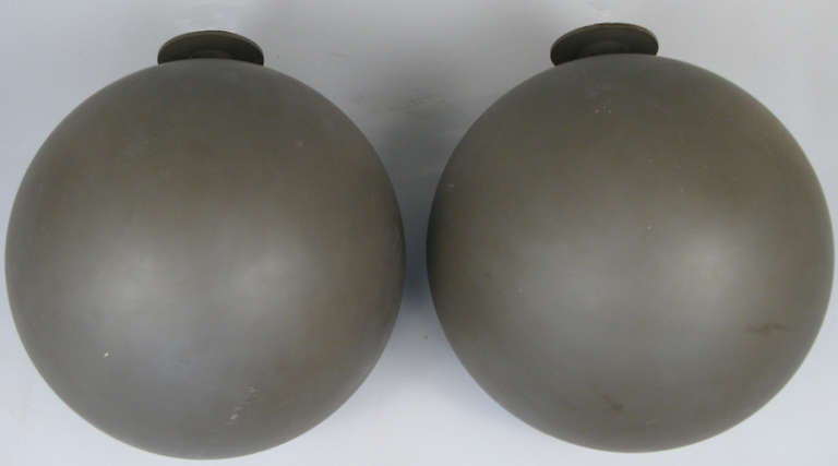 a beautiful pair of lighted wall sconces in a large sphere form originally from Avery Fisher Hall in NYC. very nice large form with original dark gray finish.