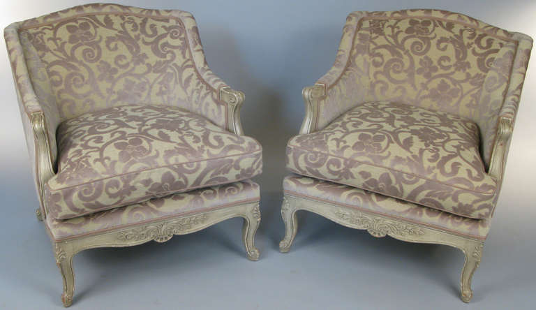 a pair of beautiful vintage carved wood frame french regency lounge chairs upholstered in nice patterned cut-velvet.