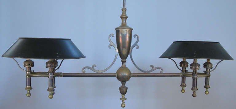 a very handsome large antique bouillote style hanging billiard light fixture. brass frame with wonderful aged patina, with a total of 6 lights, 3 at each end with enameled shades. great scale and details.