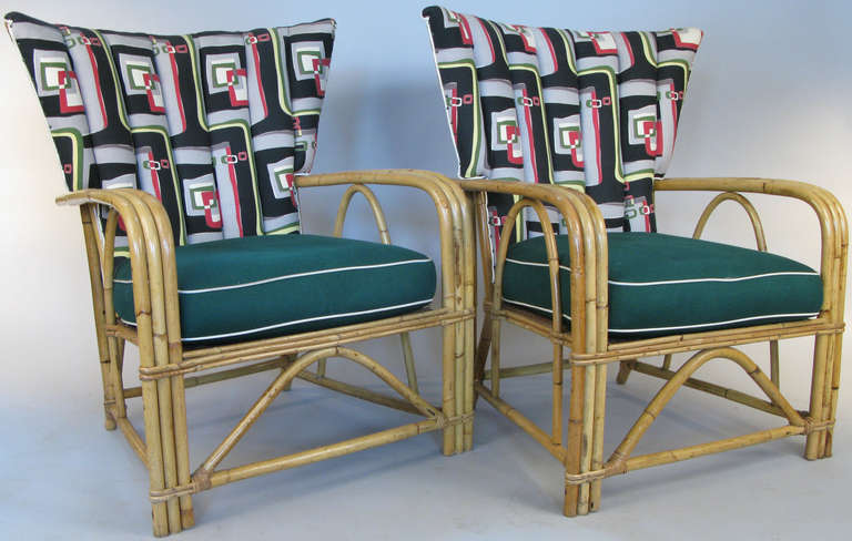 a beautiful and classic pair of 1940's rattan lounge chairs, with tall flared curved backs. original spring cushions are covered in vintage barkcloth, and the channel upholstered wide curved backs are upholstered in a classic modern geometric print