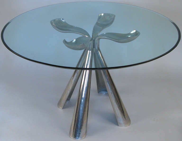 an outstanding table designed by Vittorio Introini for Saporiti Italia c. 1972. a quatrefoil base designed with 4 sculptural legs in silver plated cast aluminum, support a round bevelled glass top.