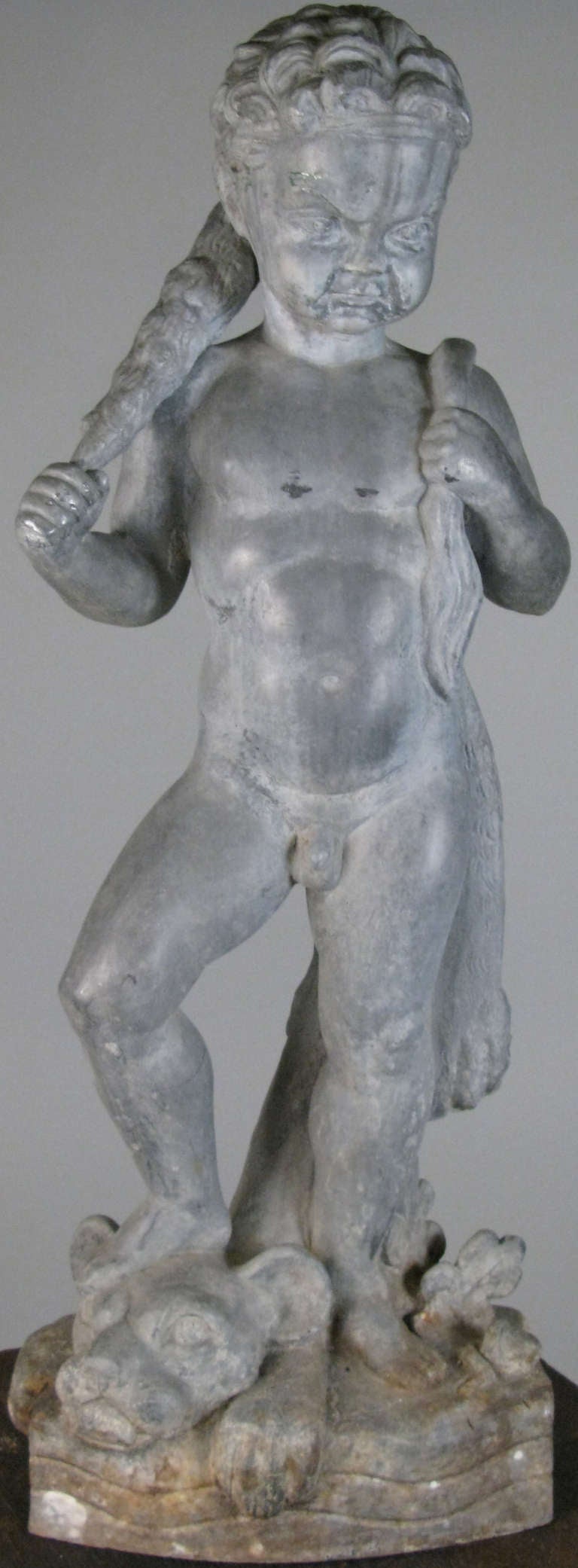 an antique Hercules cast iron sculpture by artist Wheeler Williams.