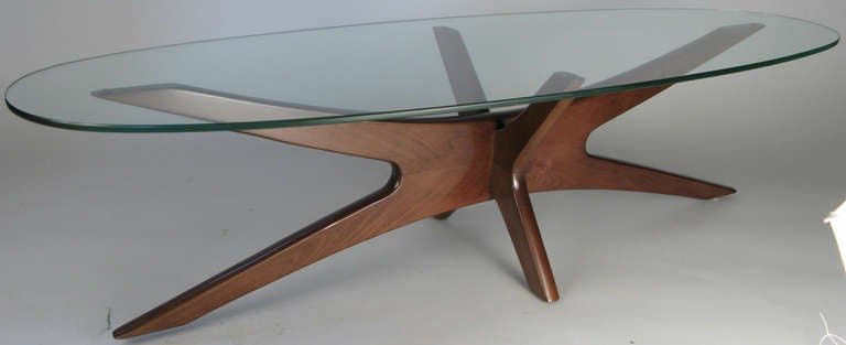 a wonderful classic modern Walnut cocktail or coffee table designed by Adrian Pearsall for Craft Associates. beautiful design with intersecting base supporting an oval glass top. perfect size and form for a sofa table.