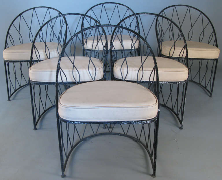 a set of very finely made and elegant wrought iron chairs made in Italy for Salterini. beautiful design with crossing bars creating a diamond pattern, and curved backs. a companion cocktail table with white glass top is also available separately.