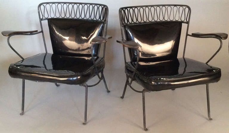 a rare pair of 1950's lounge chairs designed by Maurizio Tempestini for Salterini, from his iconic Ribbon series, with frames of wrought iron and curved backs.