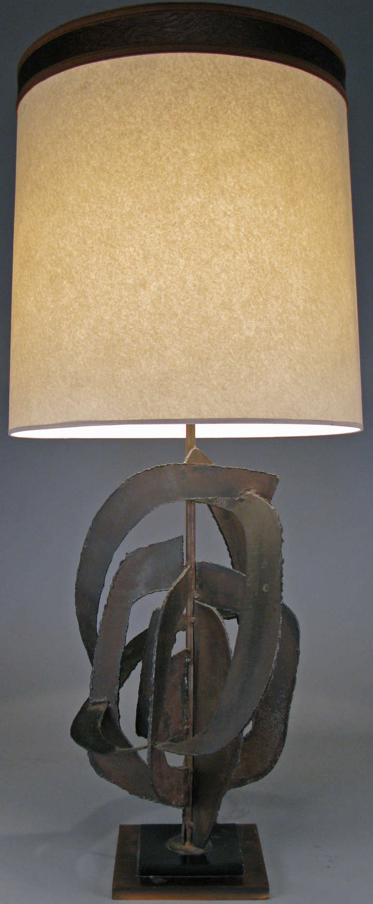 an outstanding large scale table lamp designed by Harry Balmer for Flemington Ironworks. the base of torch-cut steel in an abstract open form, welded to an iron core, raised on a stepped base of steel and copper. excellent condition.
