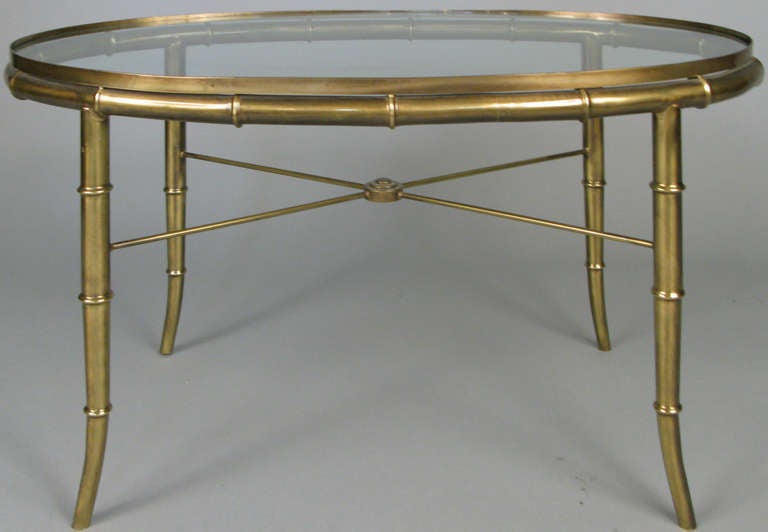 a beautiful and classic 1960's Italian brass 'Bamboo' oval cocktail table by Mastercraft. very nice detailing and extremely well made, with an X stretcher and inset glass top creating a gallery rail all around. excellent condition, marked made in