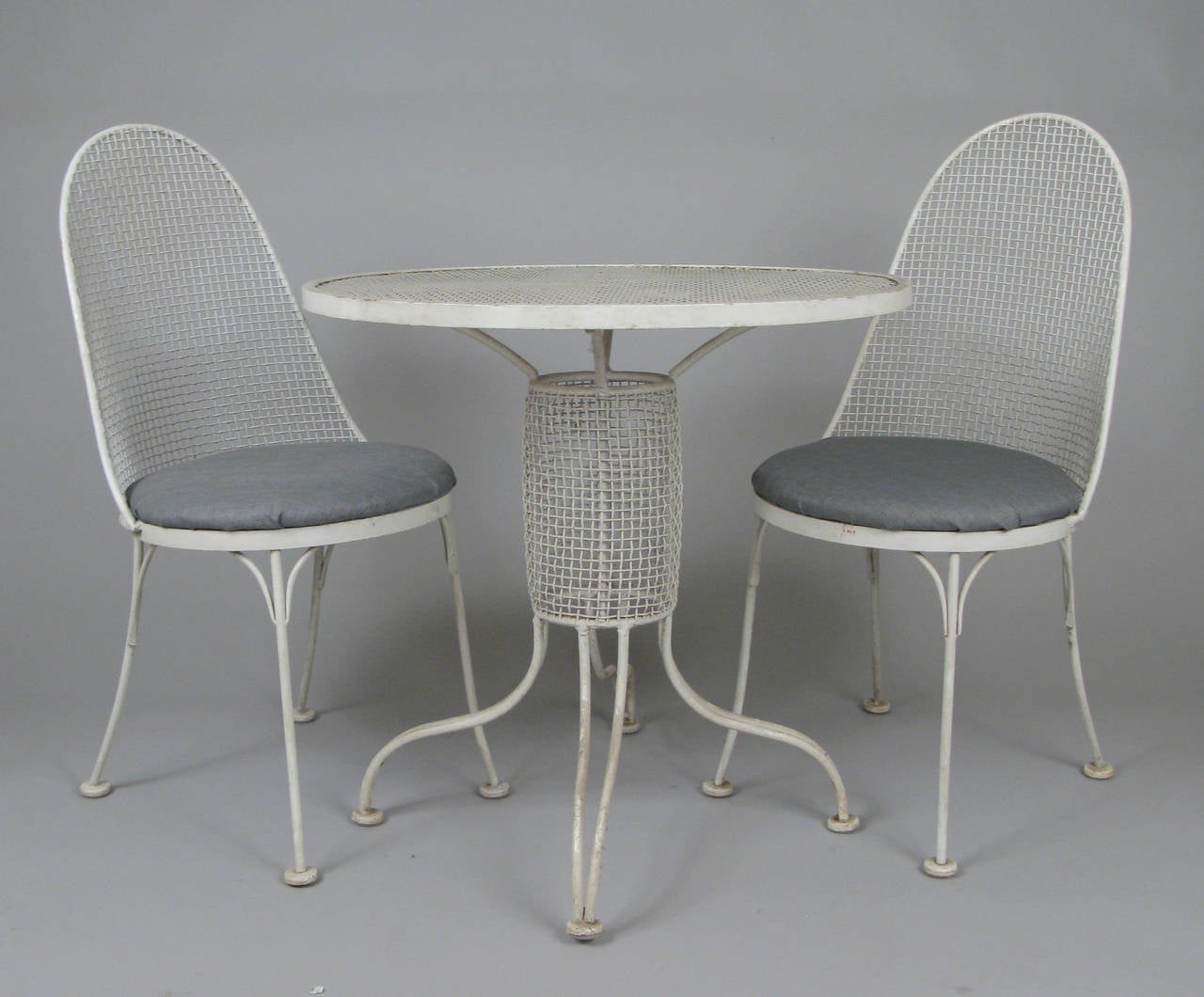 A rare set of sculpture high back chairs by Russell Woodard, along with a sculpture table with the woven mesh detailing around the center column of the table. Very nice size and scale.

The table is 30