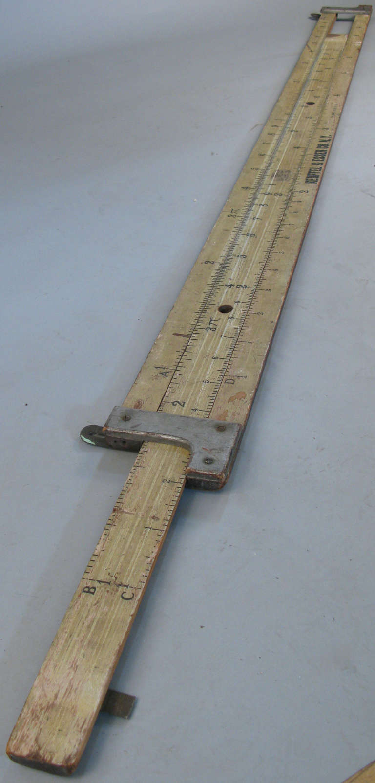 an antique monumental slide rule store display by Kueffel & Esser. Well know for their drafting tables and mathemetical instruments, this was a store display from the early 20th century.