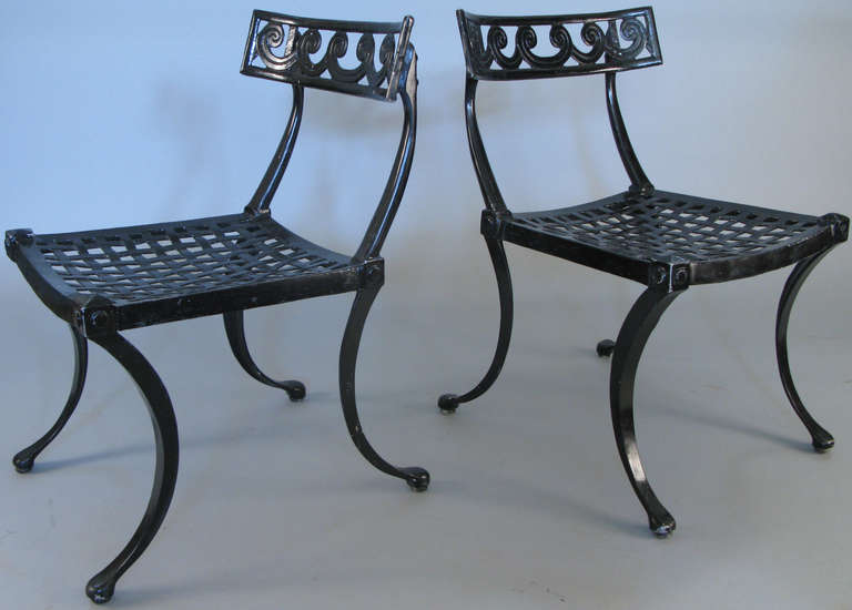 a pair of wonderful 1950's Klismos chairs in cast aluminum with lattice seats and curved backs with a Vitruvian Scroll design. beautiful scale and details.