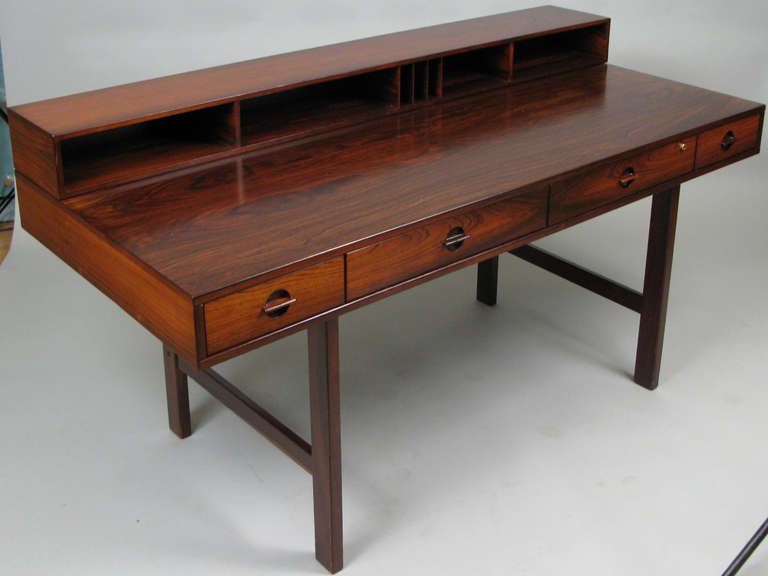 one of the most beautiful and classic of mid-century danish desks, Lovig's 'flip-top' desk is a fantastic design and beautifully made in gorgeous rosewood. the upper portion is attached with solid brass hinges and folds over and down to create a