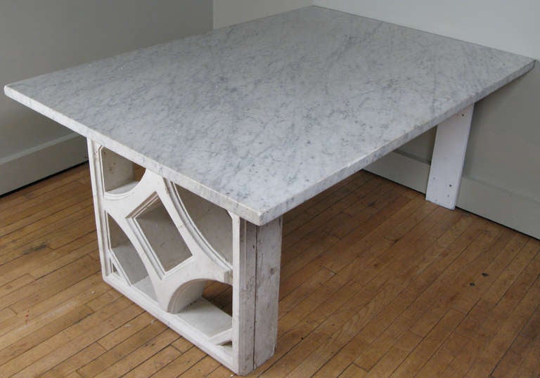 a desk made by Edward Durell Stone for his townhouse residence in new york. the marble top designed to be wall mounted, rests upon a pedestal base of a cast concrete form in a wood frame. the pedestal was a prototype for his embassy building in new