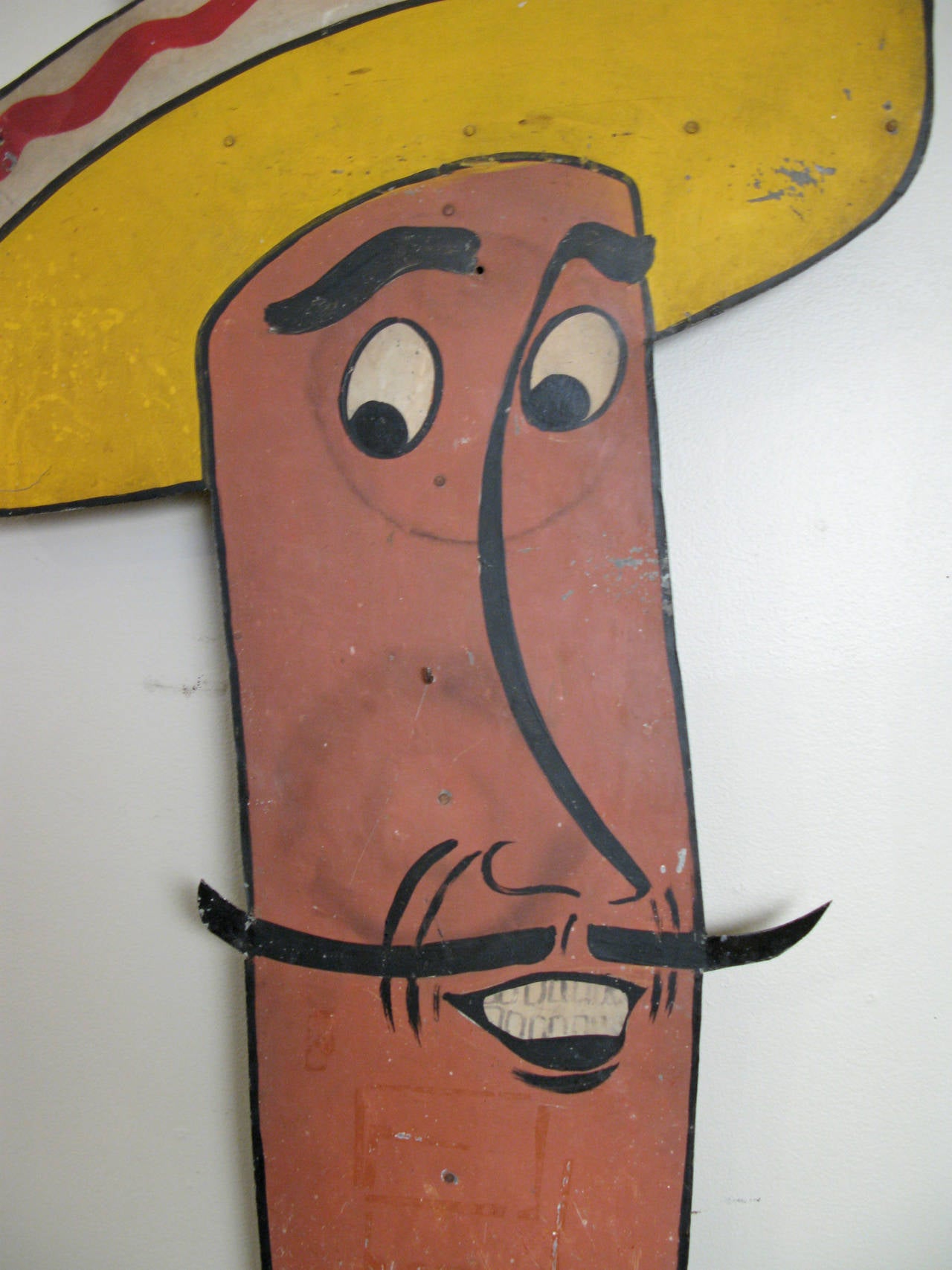 a unique and unusual antique painted metal hot dog sign, in the form of a running man dressed in a Mexican woven blanket tunic and sombrero. great character and details, in original condition.