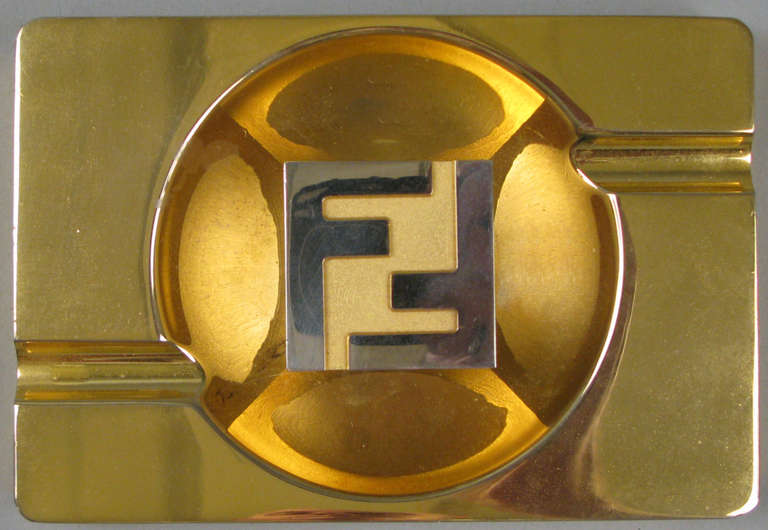 A fantastic vintage 1980s signature Fendi ashtray, finished in 18k gold. great design with a raised center with double F design, signed Fendi Roma. <br />
<br />
We also have two companion desktop pieces by Fendi, a lidded box and large desktop