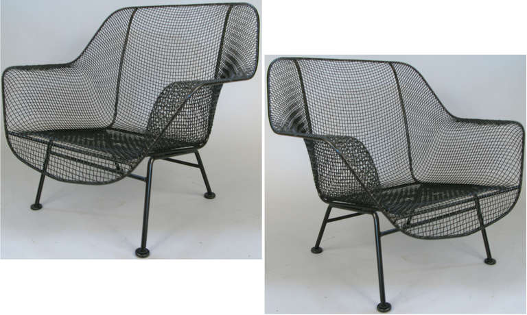 a pair of Russell Woodard's iconic Sculptura Lounge Chairs in wrought iron and woven steel mesh. very comfortable and stylish. finished in satin black, or can be finished in color of choice, and we can provide custom cushions as well.