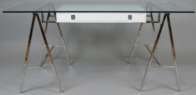 A very handsome modern 1970s writing desk with chrome sawhorses, along with a floating storage drawer beneath the glass top. Wonderful design.