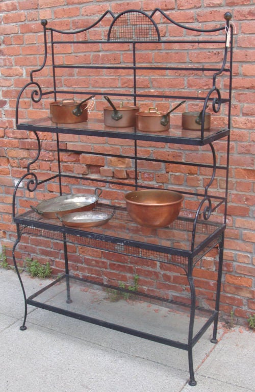 A beautiful wrought iron bakers rack in Iron by Woodard c.1950. Perfect for kitchen, terrace, or conservatory. excellent condition original black frame.