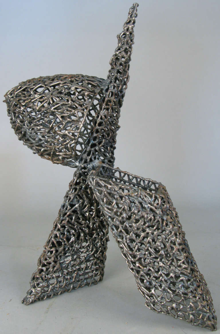 A very well done tabletop sculpture of colliding geometric forms made in open-work welded iron. Beautiful proportions.