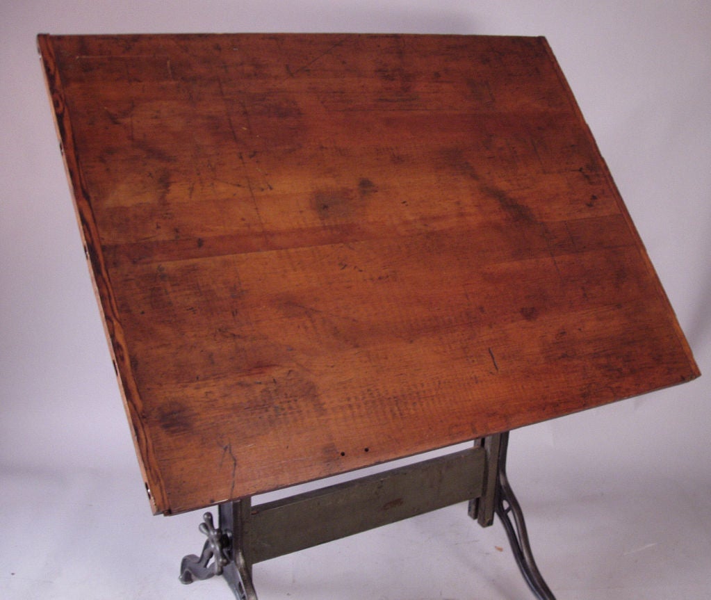 a very nice antique adjustable drafting table, with cast iron base and fully adjustable large wood top. gorgeous wood surface can be adjusted for tilt and height. fantastic patina on base and top.