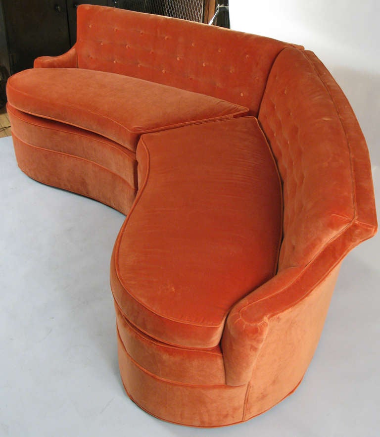 a beautiful and sculptural vintage 1940's 2 part curved sectional sofa together forming a graceful semi-circle. button tufted back and very nicely scrolled arms. just reupholstered in a very nice orange velvet. fabric samples available.