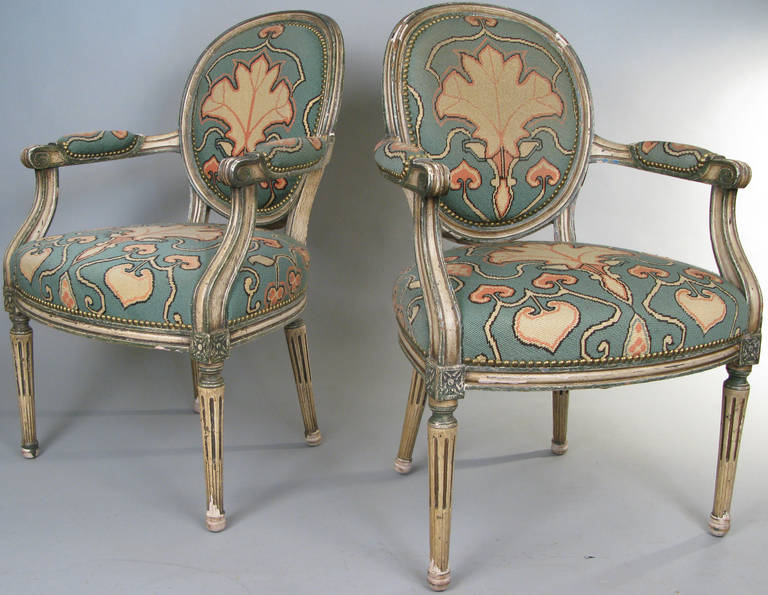 a pair of charming 1940's fauteuil with painted frames and upholstery of hand done needlepoint, with stylized leaf motif. beautifully done.