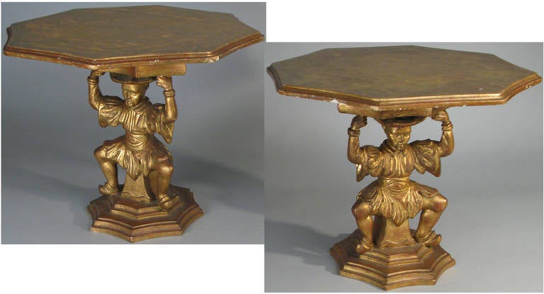 A beautiful pair of 1960s tables in gilt gold, with bases in the form of Asian men, and eight sided tops. marked Made in Italy.