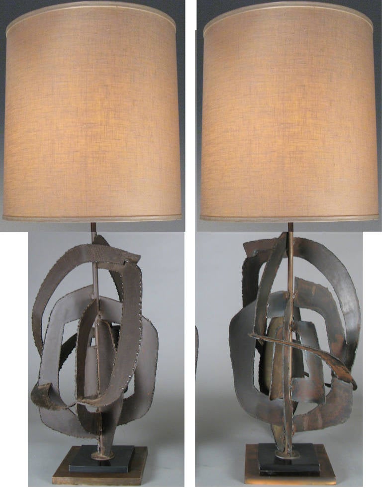 A pair of vintage table lamps designed by Harry Balmer for Flemington Ironworks,  made from torch cut steel and iron in an open abstract form, on a steel and copper base. shades not included.
