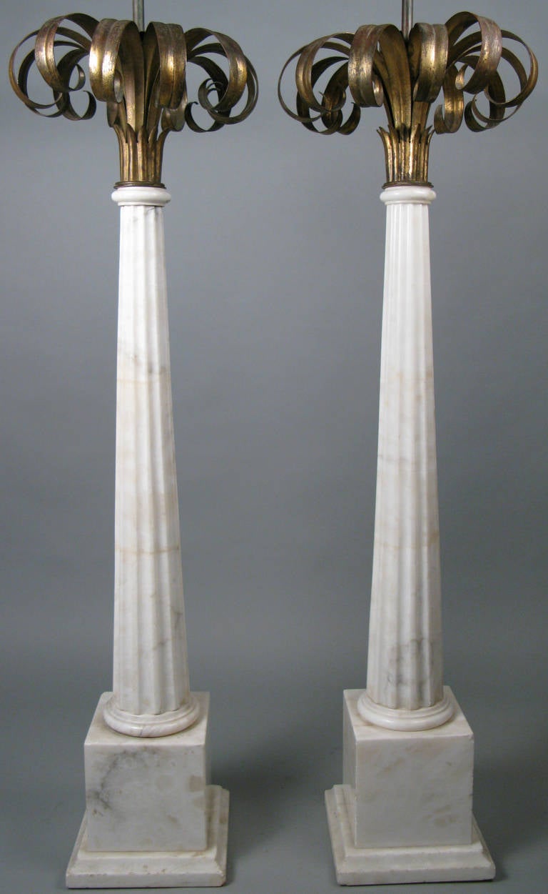 A truly amazing pair of 1940s Italian floor lamps, with tall bases of stacked and fluted marble columns, surmounted by a large spray of gilded palms.