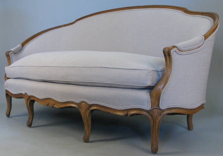 A beautiful large french style sofa with carved wood frame and down seat cushion, just upholstered in greige linen. very well made and in perfect condition.
