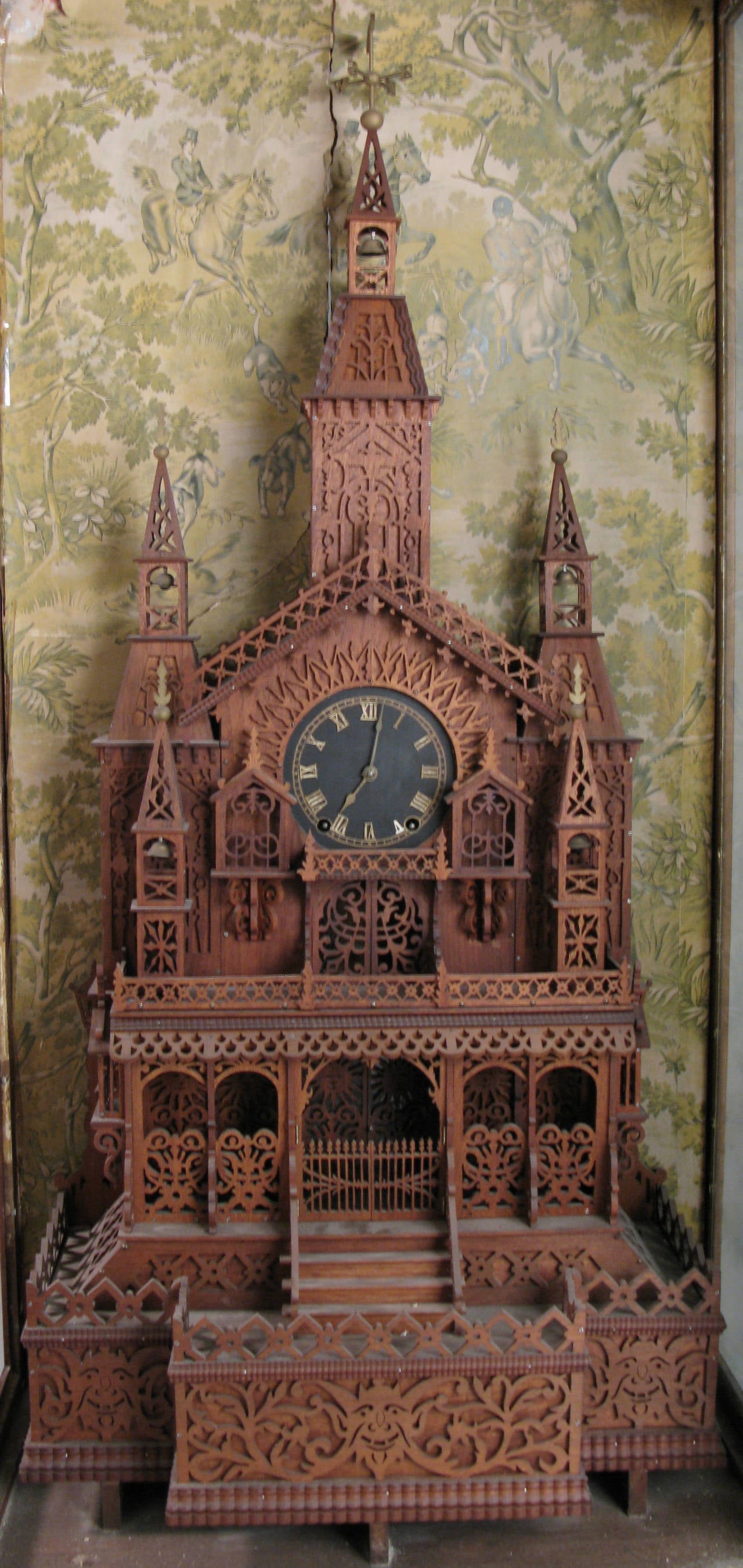 A charming large-scale very elaborate fork art replica of a cathedral, done in whittled wood, in its original period oak and glass display case, with period English wallpaper depicting a fox hunt.